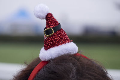 Cropped image of person wearing santa hat during christmas