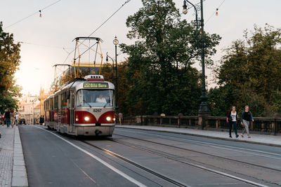 Train on railroad tracks in city against sky