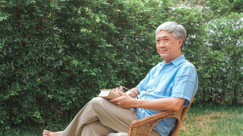 Smiling siting on chair in yard