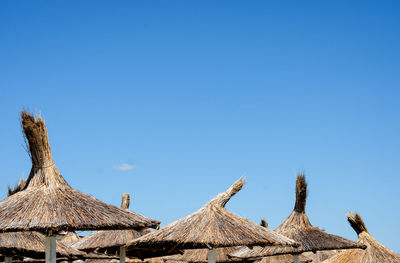 Low angle view of roof against clear blue sky