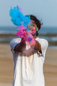 Midsection of woman standing against sea