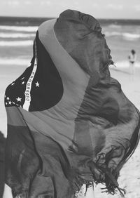 Close-up of man on beach against sky