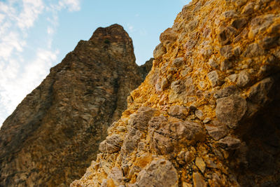 Low angle view of rock formation against sky