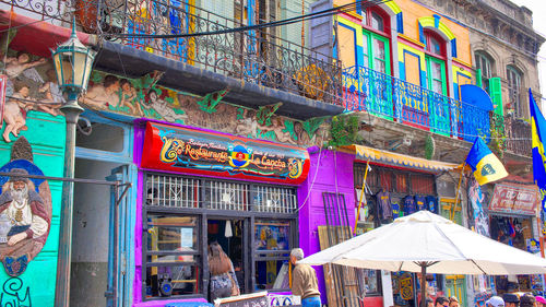 People at market stall building