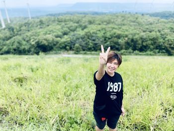 Portrait of smiling girl standing on field