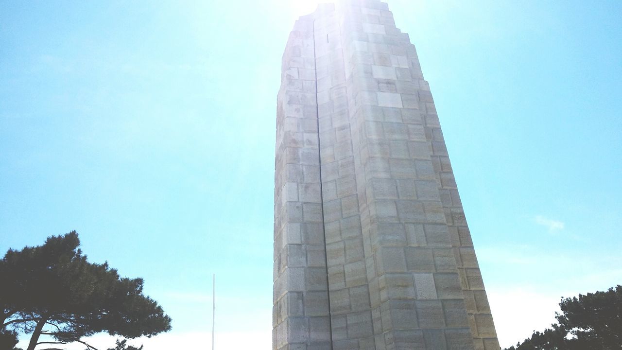 architecture, built structure, low angle view, clear sky, building exterior, blue, day, outdoors, tower, no people, city, skyscraper, sky, tree, nature