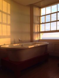 Free standing bathtub by window in bathroom