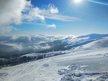 Scenic view of snow covered mountains against sky