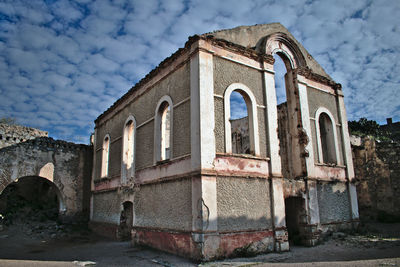 Low angle view of old building against sky