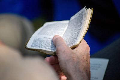 Close-up of hand holding book