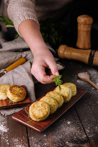 Cropped hand of person preparing food