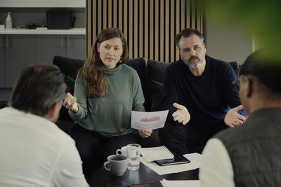 Side view of business colleagues working in office