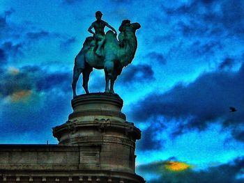 Low angle view of monument against cloudy sky