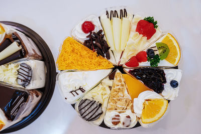 Fresh milk cakes and a variety of fruits that are beautifully decorated, look attractive.
