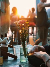 Close-up of woman sitting on table at sidewalk cafe