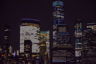 Illuminated buildings against sky at night