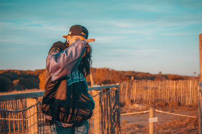 Rear view of man standing against sky