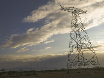 Low angle view of wind turbines at sunset