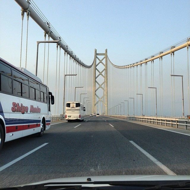 transportation, built structure, architecture, clear sky, connection, bridge - man made structure, road, the way forward, road marking, engineering, car, mode of transport, land vehicle, diminishing perspective, bridge, building exterior, copy space, street, vanishing point, day