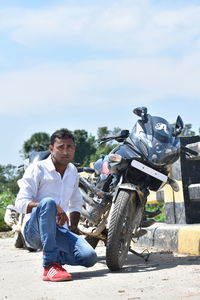 Full length of man riding motorcycle against sky