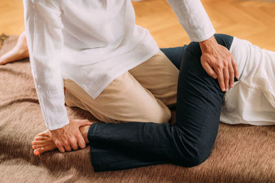 Therapist stretching womans leg. shiatsu massage.