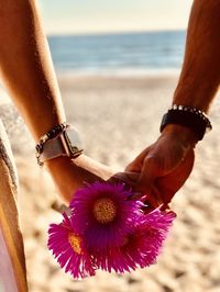 Couple hands holding flower