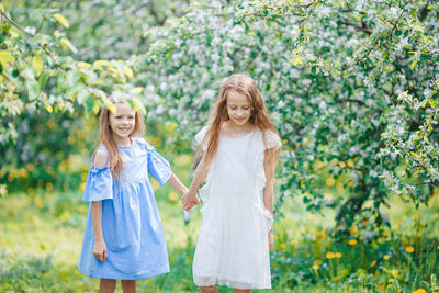 Portrait of a smiling girl standing against plants