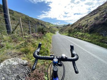 Bicycle on road by mountain against sky. majestic ride in wales. road cycling. hills. climbing. 