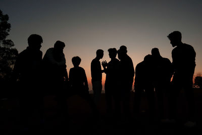 Silhouette people at sunset