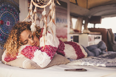 Mature woman sleeping on bed in motor home