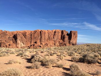 Rock formations in desert against blue sky