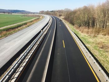 View of empty road along trees