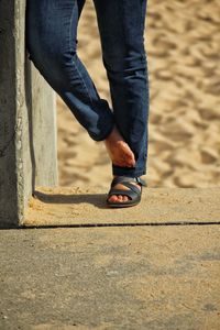 Low section of man standing on footpath