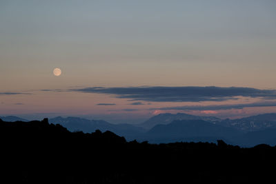 Scenic view of mountains against sky at dusk