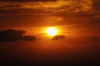 Scenic view of sun shining in sky during sunset