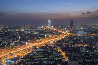 High angle view of illuminated cityscape against sky at night