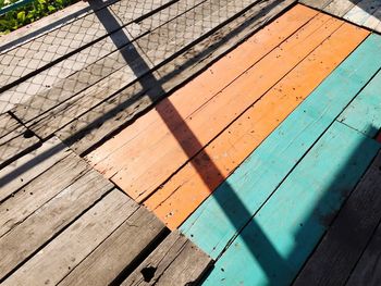 High angle view of wooden footbridge during sunny day