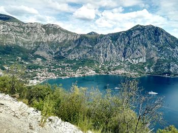 Scenic view of lake and rocky mountains against sky