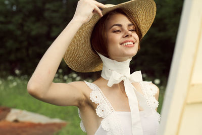 Portrait of young woman wearing hat