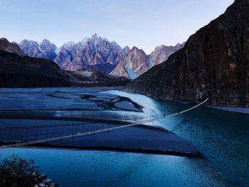 Scenic view of snowcapped mountains against blue sky