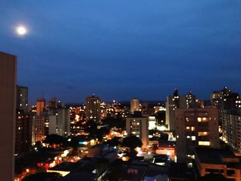 Illuminated cityscape against clear sky