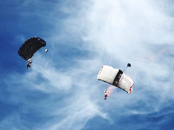 Low angle view of helicopter flying in sky