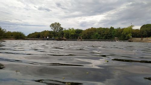 Surface level of lake against sky