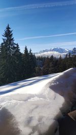 Scenic view of snowcapped mountains against blue sky