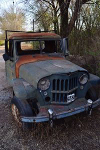 Abandoned car on field