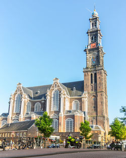 Cathedral against blue sky and buildings in city