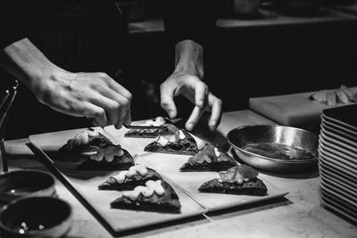 Midsection of person preparing food on table