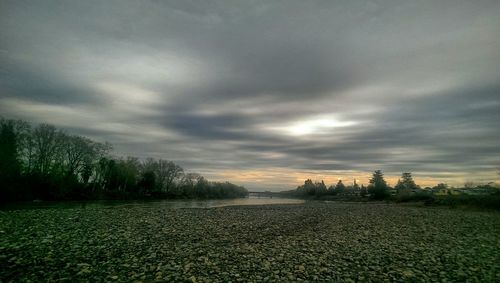 Scenic view of field against sky at sunset