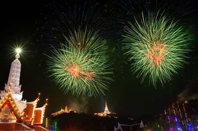 Low angle view of firework display at night