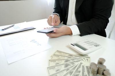 Midsection of man working on table